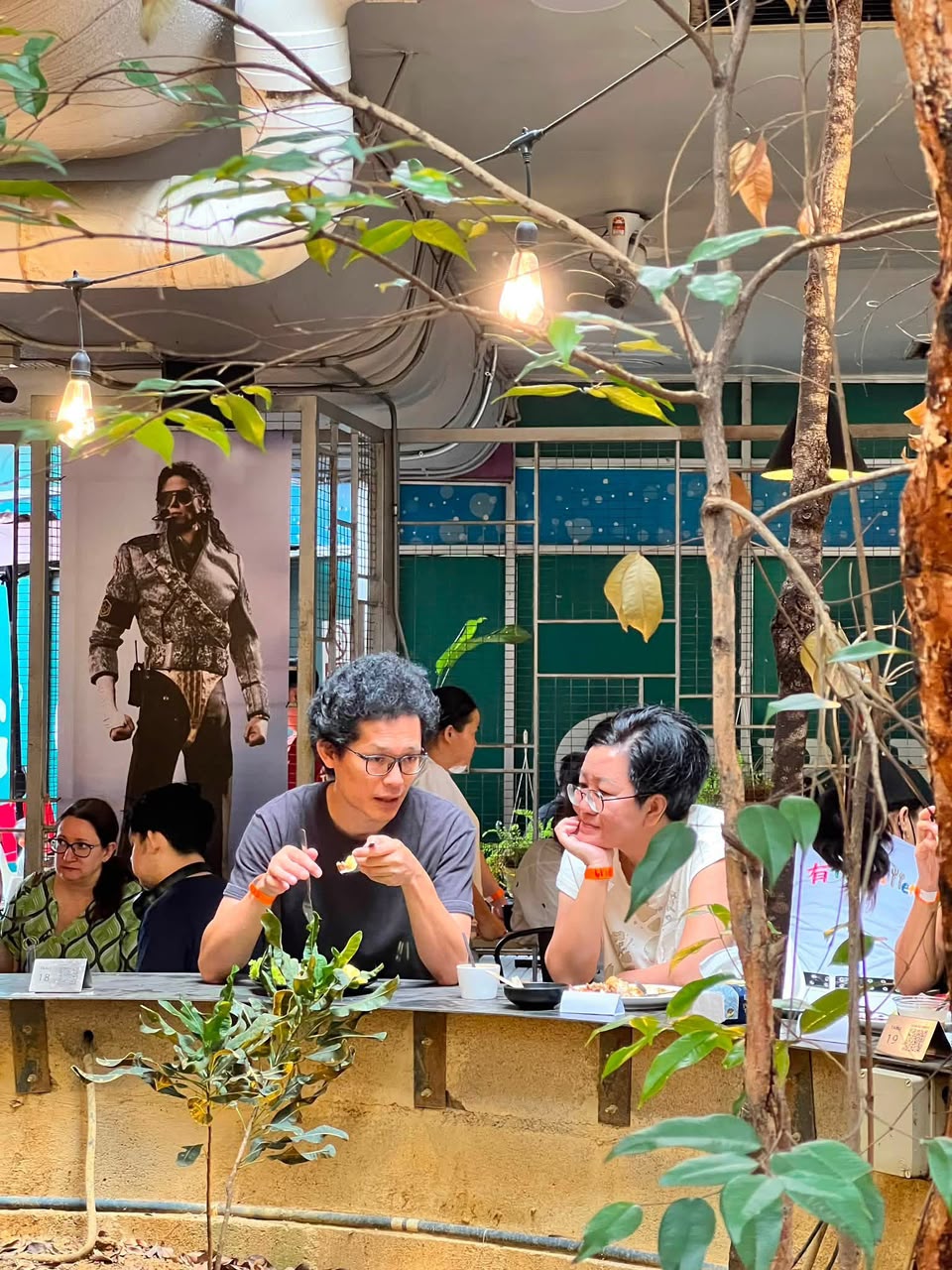Guests dining under the garden trees