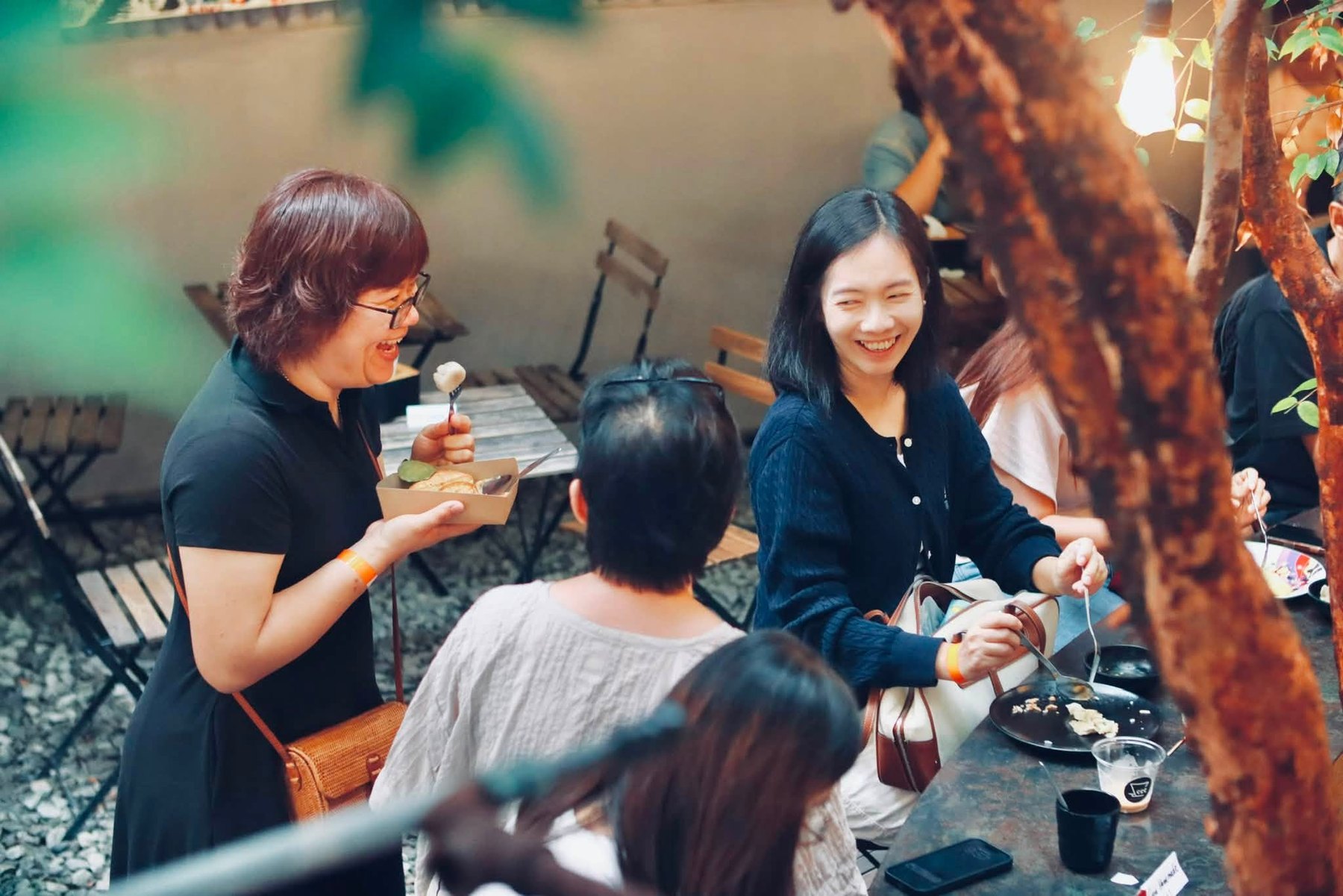 Friends smiling together in the garden dining area